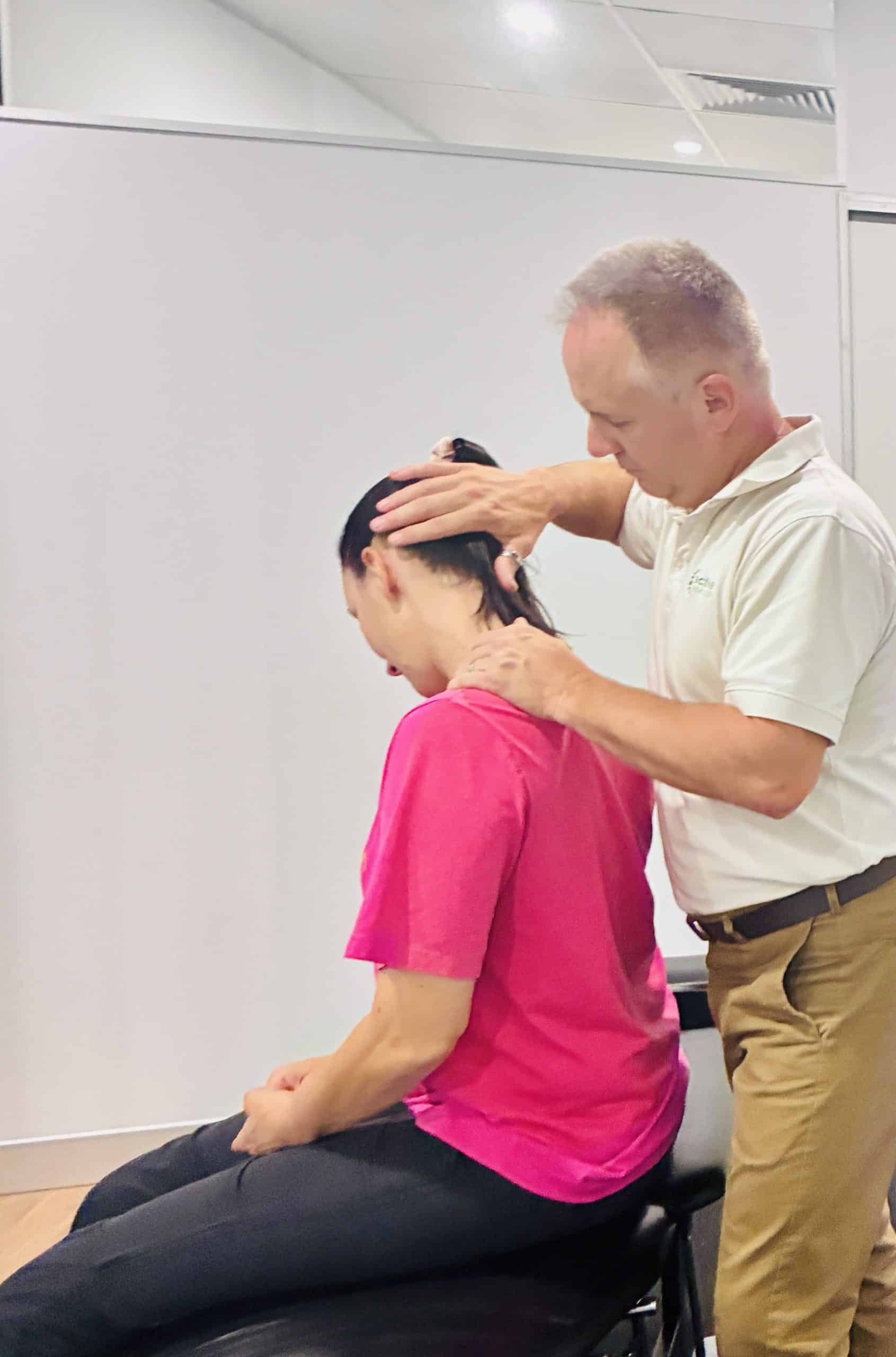 Dr Mark Whitfield performing cervical mobilization at Corrective Chiropractic Calamvale